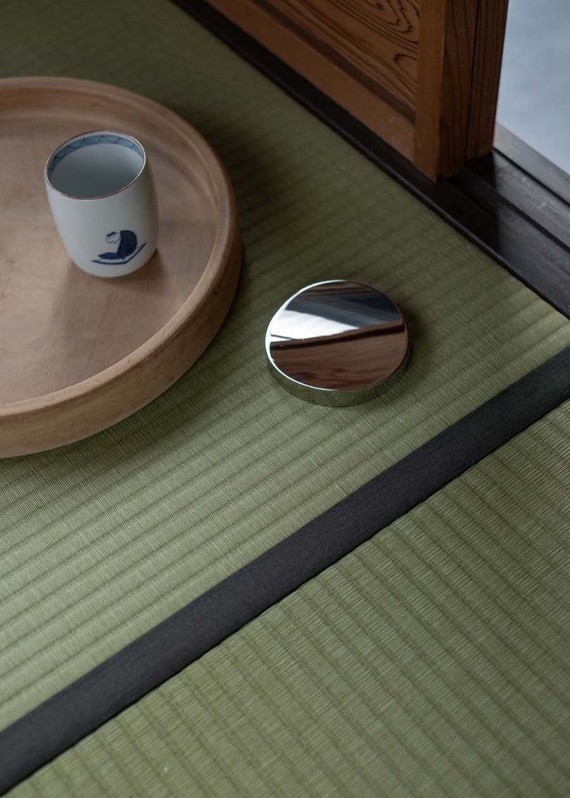 Wooden tray and noon all day vitamin storage vessel on a tatami mat with a wooden frame in the background
