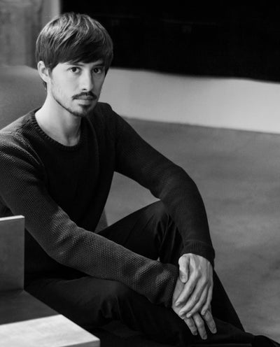 Federico Peri sitting on a bench in a black and white photo
