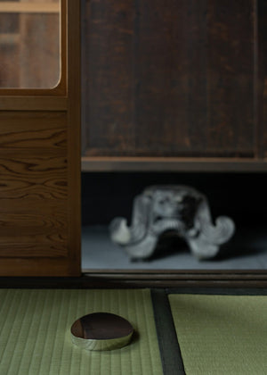 Traditional Japanese interior with wooden cabinet and tatami mat flooring.