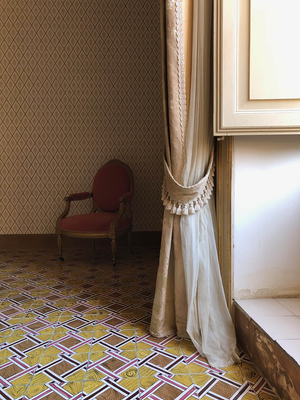 A photo in the interior of a palazzo with sunlight coming through the window